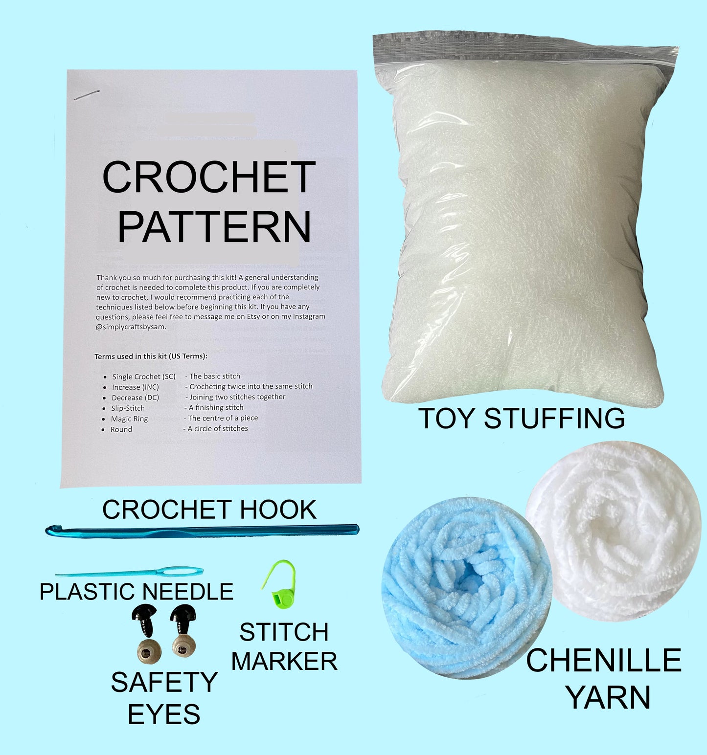 Contents of the whale crochet kit spread out including crochet pattern, toy stuffing, crochet hook, plastic needle, safety eyes, stitch marker, and chenille yarn